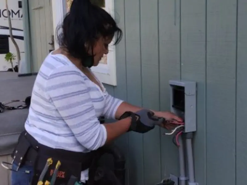Licensed electrician wiring an exterior subpanel in Bunkie